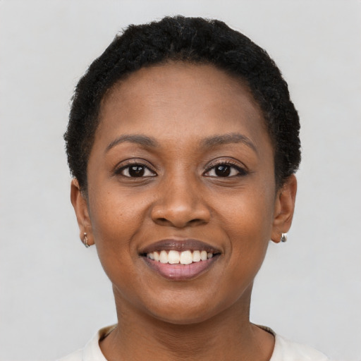 Joyful black young-adult female with short  brown hair and brown eyes