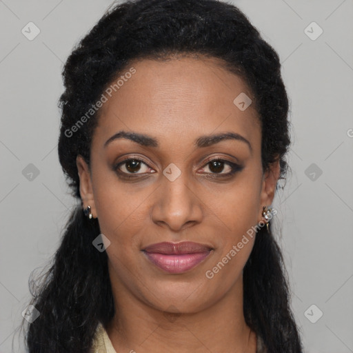 Joyful black young-adult female with long  black hair and brown eyes