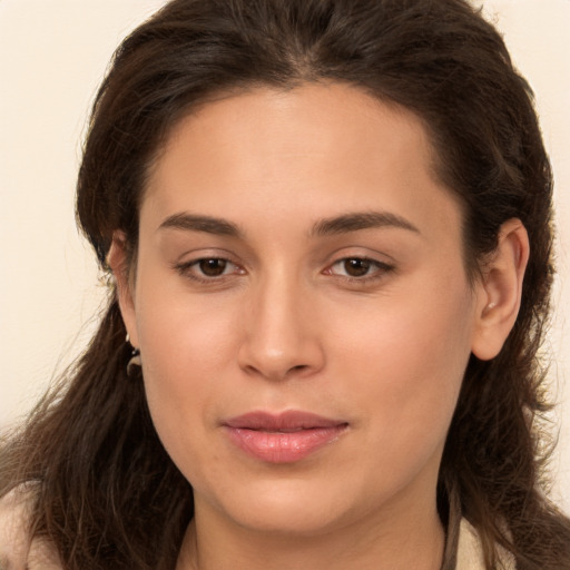 Joyful white young-adult female with long  brown hair and brown eyes