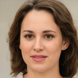 Joyful white young-adult female with medium  brown hair and green eyes