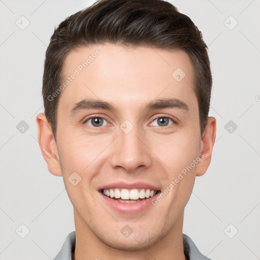 Joyful white young-adult male with short  brown hair and grey eyes