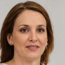 Joyful white adult female with medium  brown hair and brown eyes