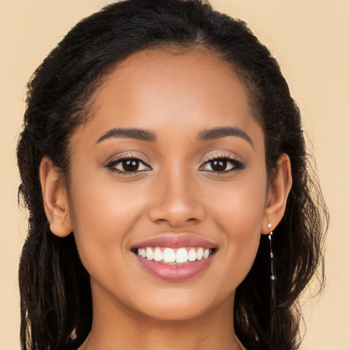 Joyful latino young-adult female with long  brown hair and brown eyes