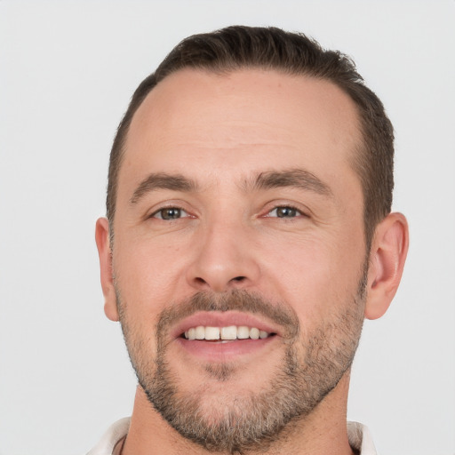 Joyful white adult male with short  brown hair and brown eyes