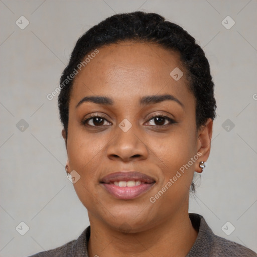 Joyful black young-adult female with short  black hair and brown eyes