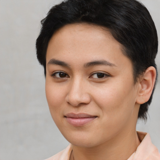 Joyful asian young-adult female with short  brown hair and brown eyes