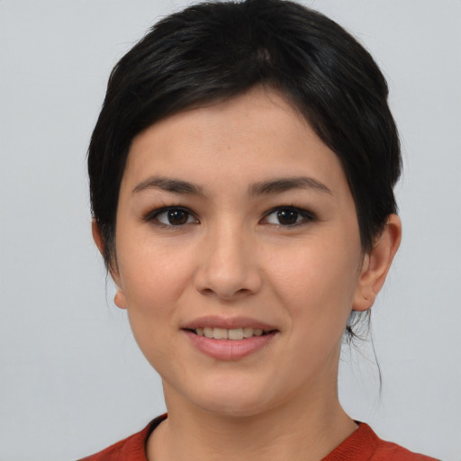 Joyful asian young-adult female with short  brown hair and brown eyes