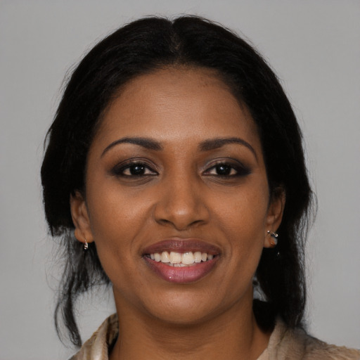 Joyful black young-adult female with medium  brown hair and brown eyes