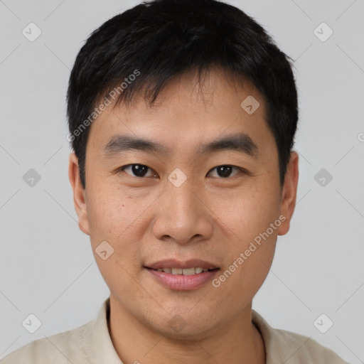 Joyful asian young-adult male with short  black hair and brown eyes