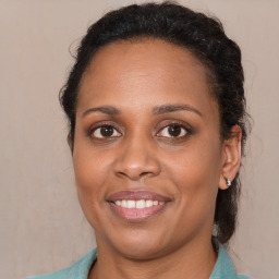 Joyful latino adult female with medium  brown hair and brown eyes