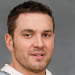 Joyful white young-adult male with short  brown hair and brown eyes