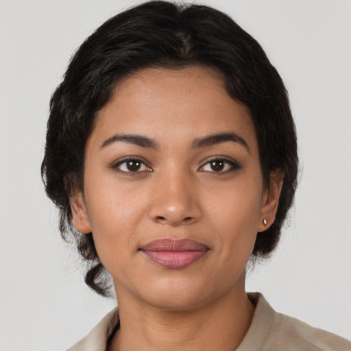 Joyful latino young-adult female with medium  brown hair and brown eyes