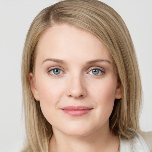 Joyful white young-adult female with medium  brown hair and blue eyes