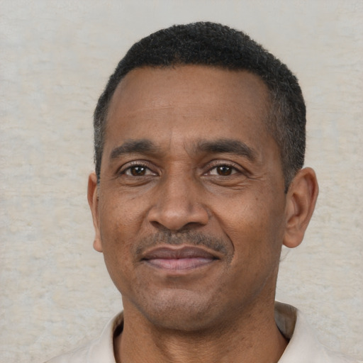 Joyful latino adult male with short  black hair and brown eyes
