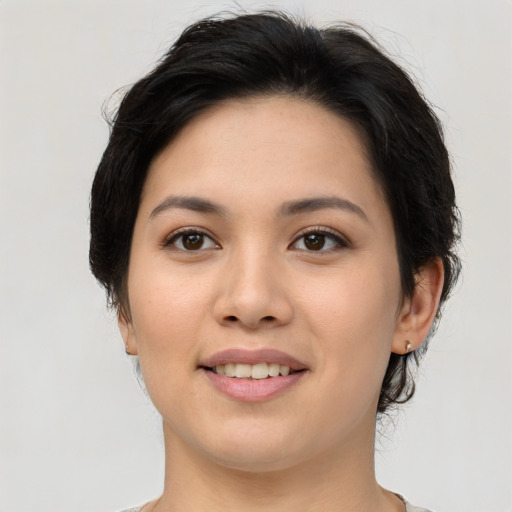 Joyful asian young-adult female with short  brown hair and brown eyes