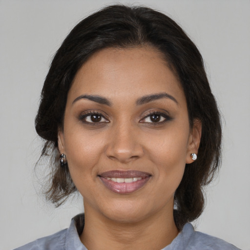 Joyful black young-adult female with medium  brown hair and brown eyes