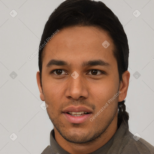 Joyful latino young-adult male with short  black hair and brown eyes
