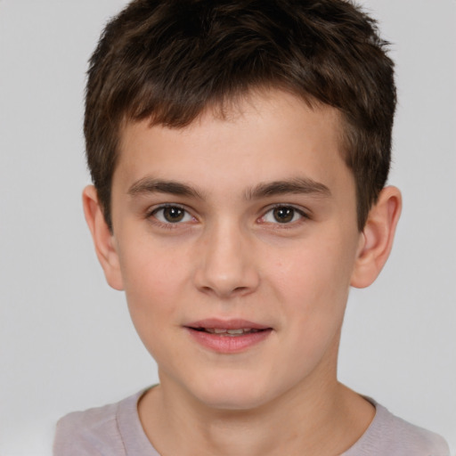 Joyful white child male with short  brown hair and brown eyes