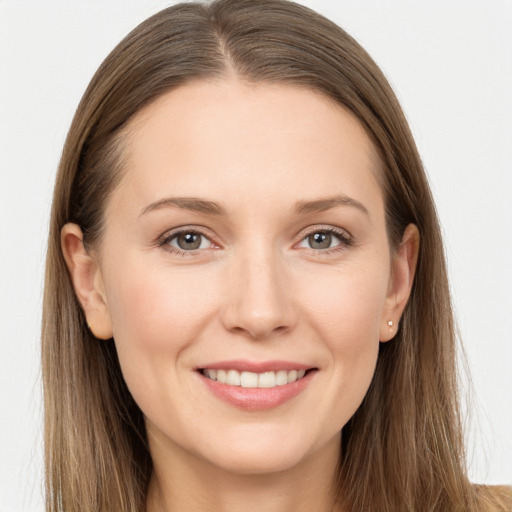 Joyful white young-adult female with long  brown hair and grey eyes