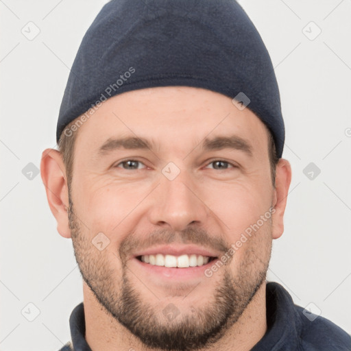 Joyful white young-adult male with short  brown hair and brown eyes