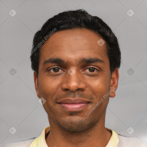 Joyful black young-adult male with short  black hair and brown eyes