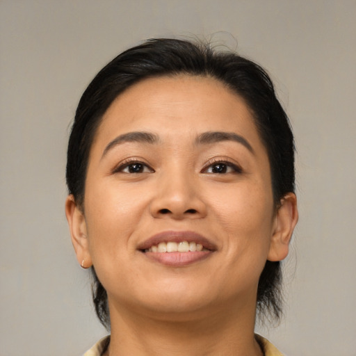 Joyful latino young-adult female with medium  brown hair and brown eyes