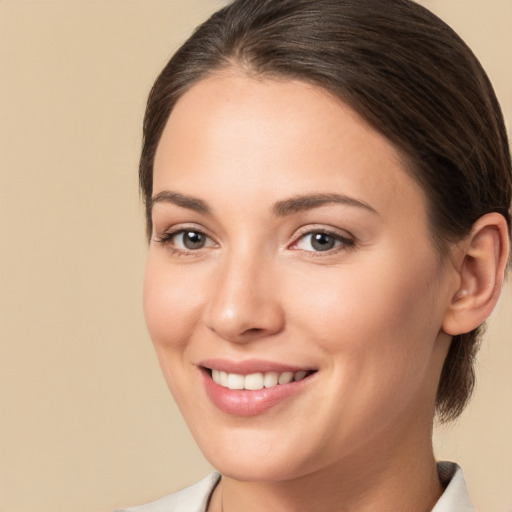 Joyful white young-adult female with medium  brown hair and brown eyes