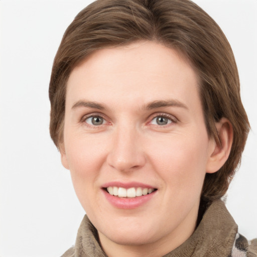 Joyful white young-adult female with medium  brown hair and grey eyes