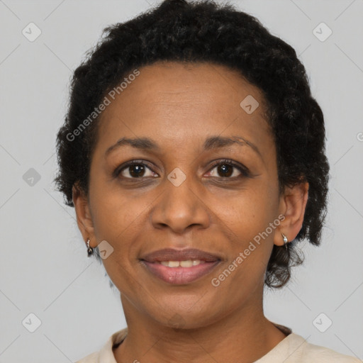 Joyful black adult female with short  brown hair and brown eyes