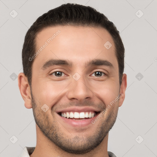 Joyful white young-adult male with short  brown hair and brown eyes