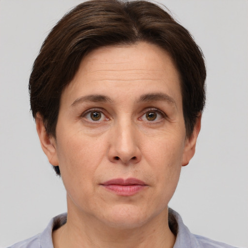 Joyful white adult female with short  brown hair and brown eyes