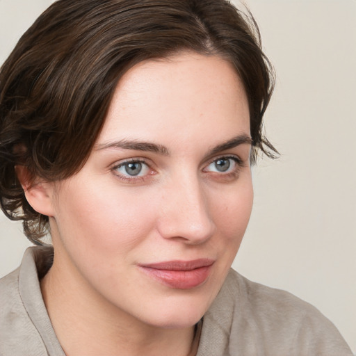 Joyful white young-adult female with medium  brown hair and blue eyes