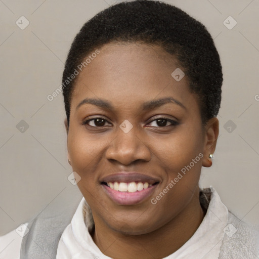 Joyful black young-adult female with short  brown hair and brown eyes