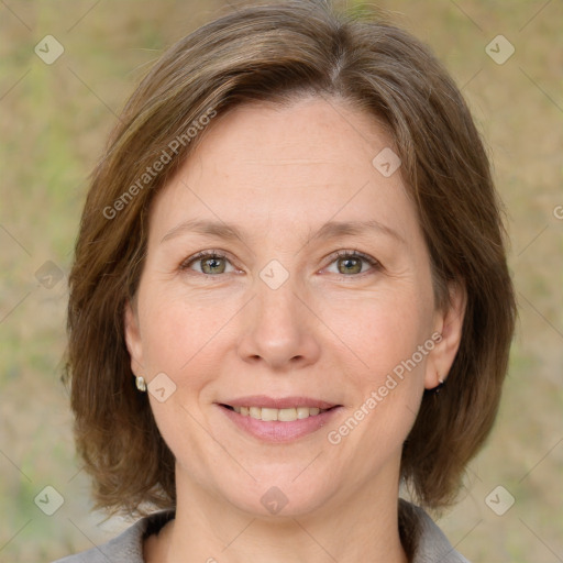 Joyful white adult female with medium  brown hair and grey eyes