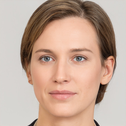 Joyful white young-adult female with medium  brown hair and grey eyes