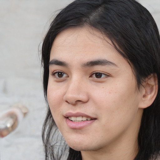 Joyful white young-adult male with medium  black hair and brown eyes