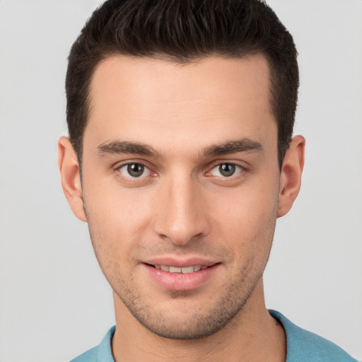 Joyful white young-adult male with short  brown hair and brown eyes