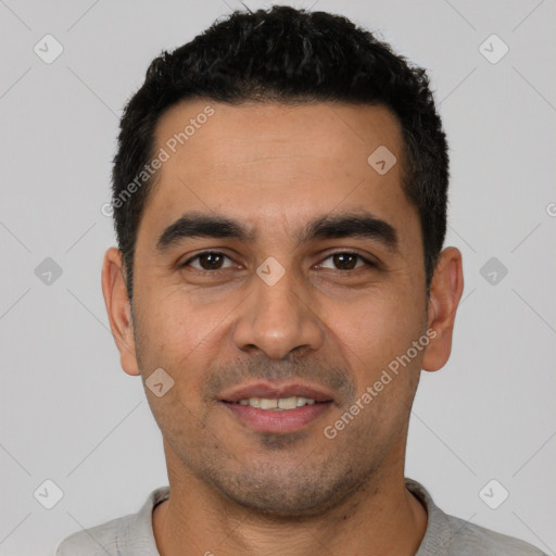 Joyful latino young-adult male with short  black hair and brown eyes