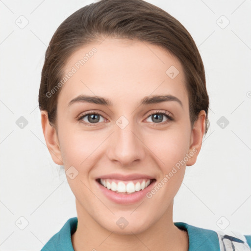 Joyful white young-adult female with short  brown hair and grey eyes