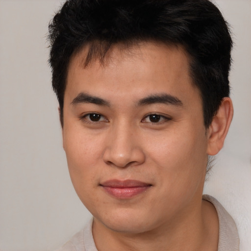 Joyful asian young-adult male with short  brown hair and brown eyes