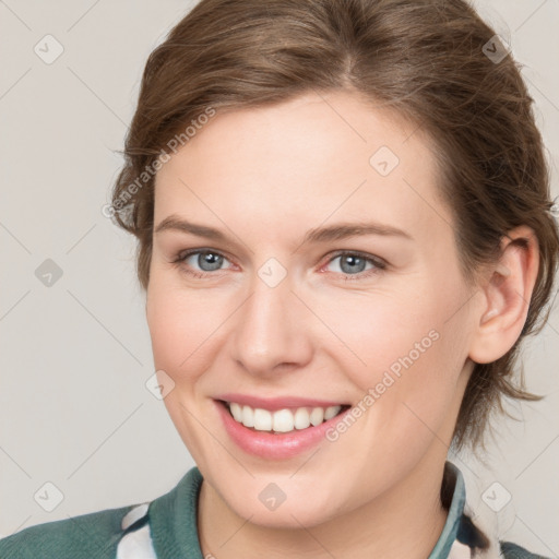 Joyful white young-adult female with medium  brown hair and grey eyes