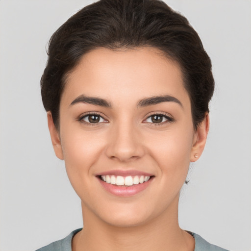 Joyful white young-adult female with short  brown hair and brown eyes