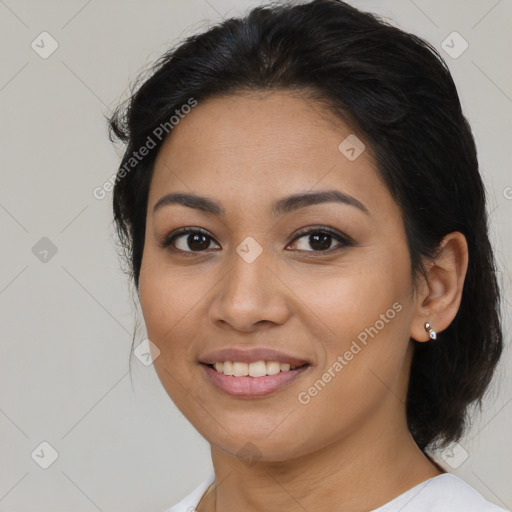 Joyful latino young-adult female with medium  brown hair and brown eyes