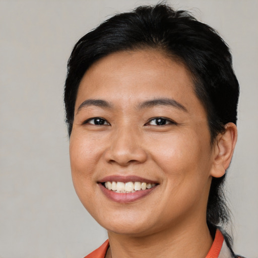 Joyful asian young-adult female with short  brown hair and brown eyes