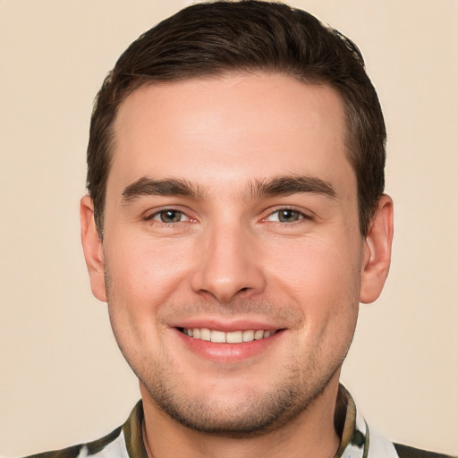 Joyful white young-adult male with short  brown hair and brown eyes