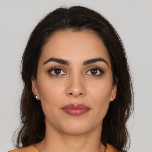 Joyful white young-adult female with long  brown hair and brown eyes