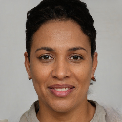 Joyful white adult female with short  black hair and brown eyes