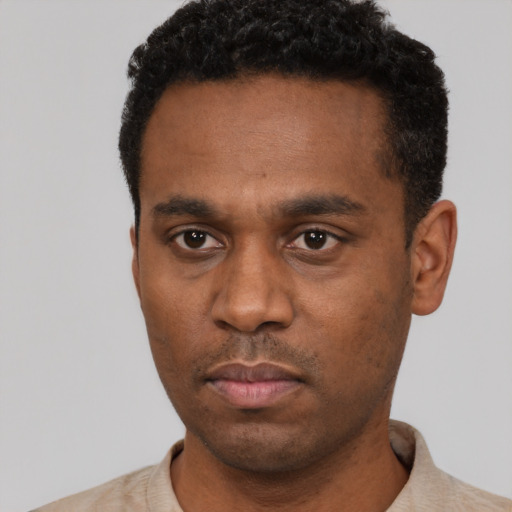 Neutral black young-adult male with short  black hair and brown eyes