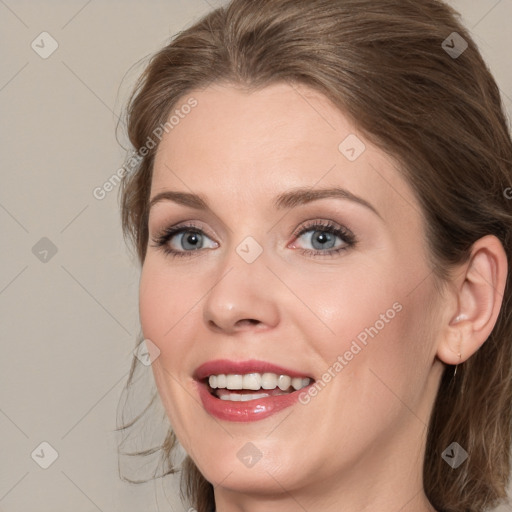 Joyful white young-adult female with medium  brown hair and blue eyes