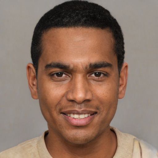 Joyful black young-adult male with short  black hair and brown eyes